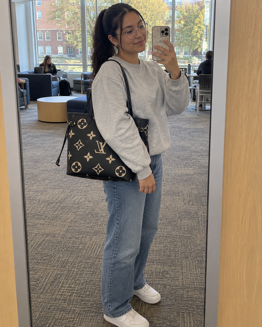 AI-generated styling illustration: black and beige tote on a university campus.