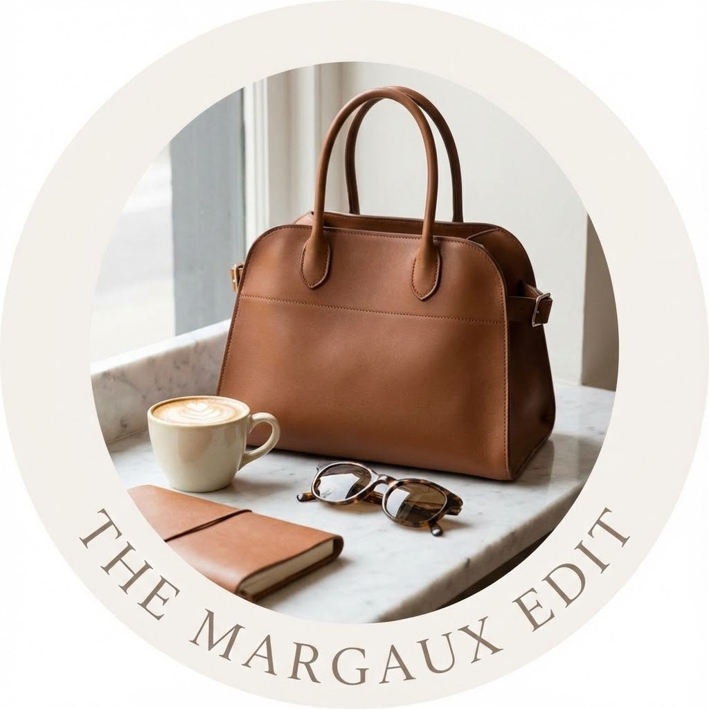 A circular profile picture showing a black The Row Margaux top-handle bag placed on a clean white surface, representing a curated handbag collection."