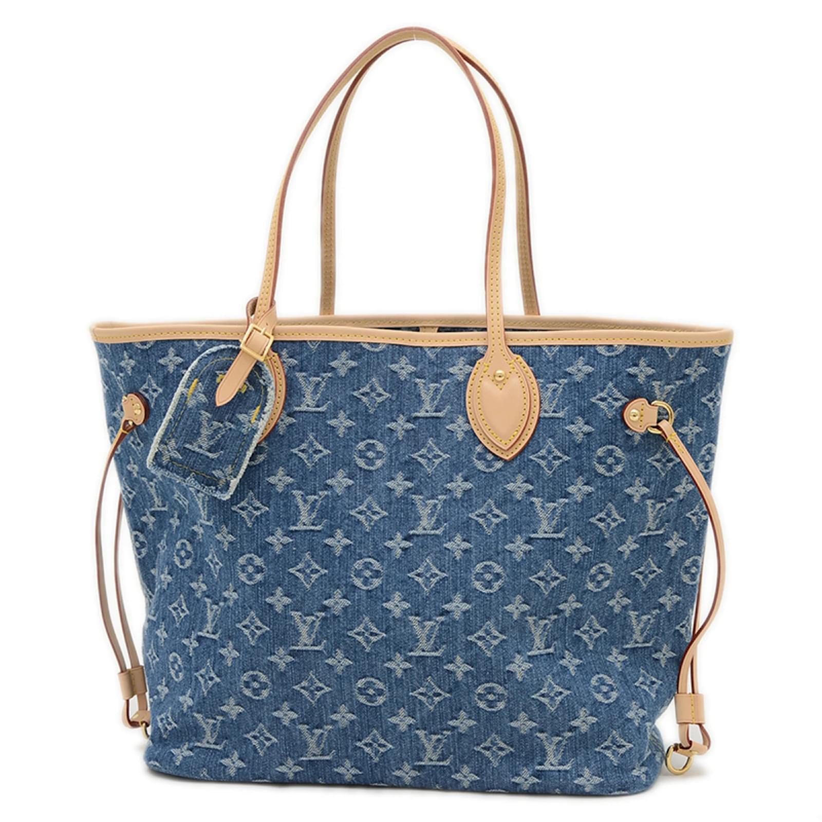 Denim neverfull-style tote bag with slim shoulder handles and adjustable side laces on white background